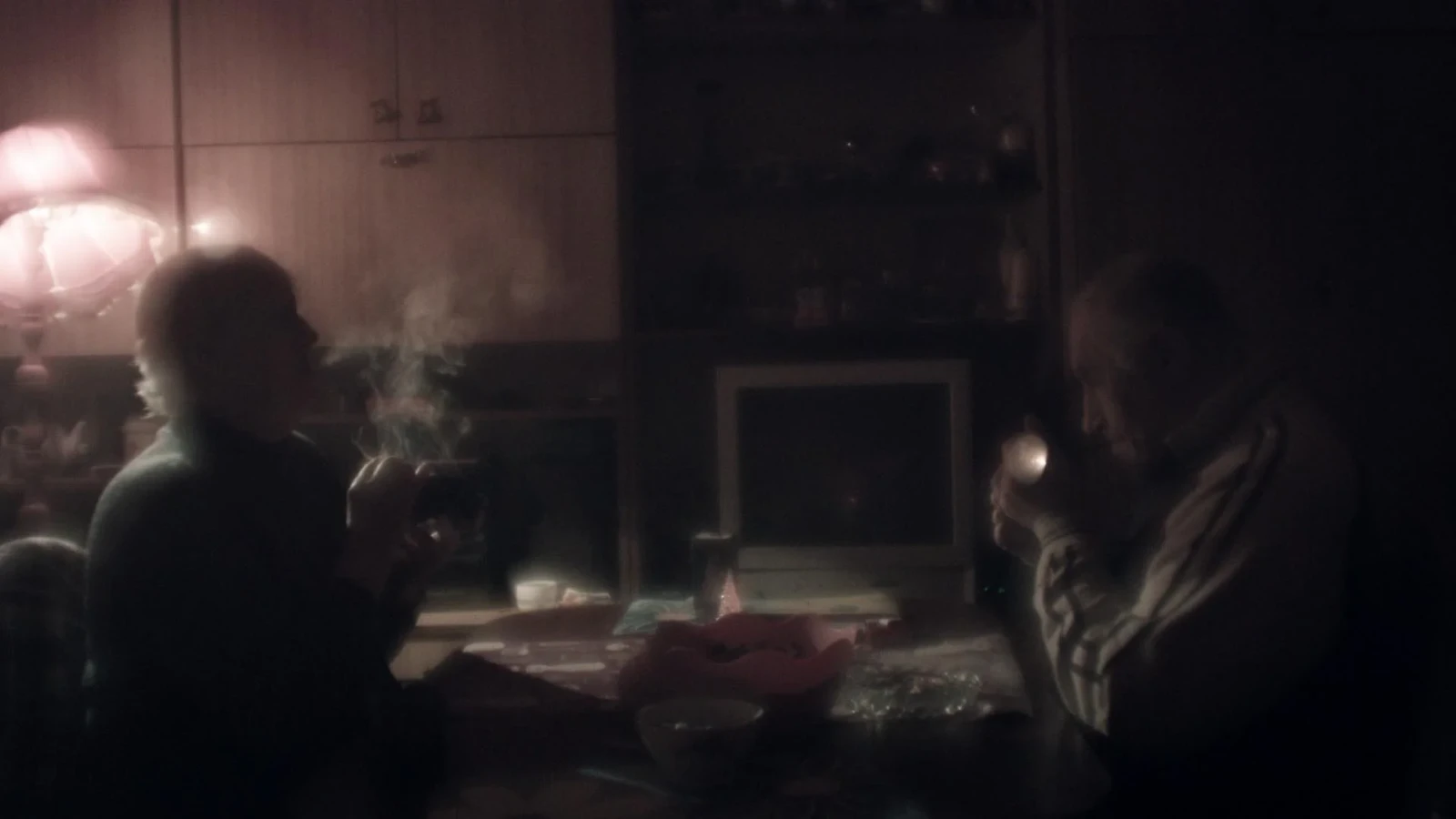 Couple in a room smoking cigarettes