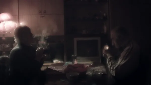 Couple in a room smoking cigarettes