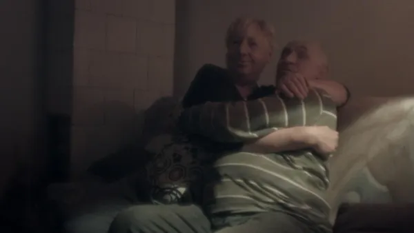 Couple in a room smoking cigarettes